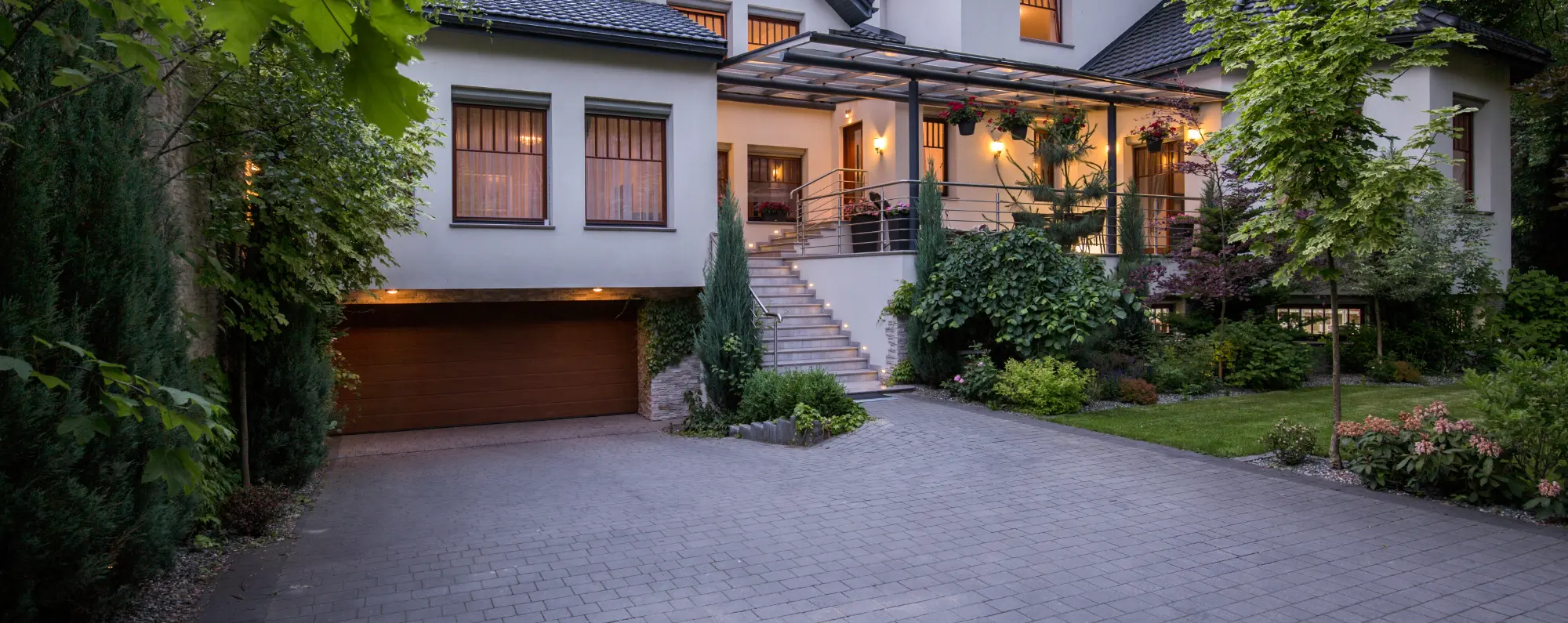 Landscaped front yard with brick driveway