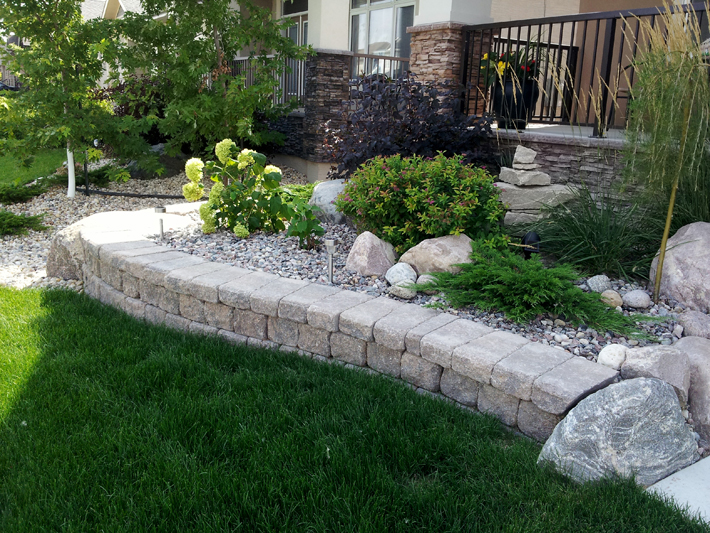 Stone work around shrub bed on Lake Forest Road