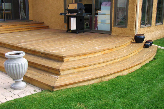 Low cedar deck with wide curved steps on Shamrock Dr