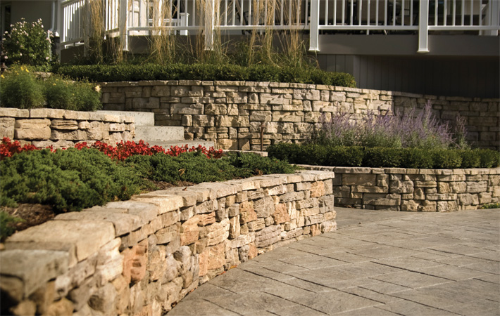 Series of natural Belvedere stone retaining walls with brick patio and stone steps