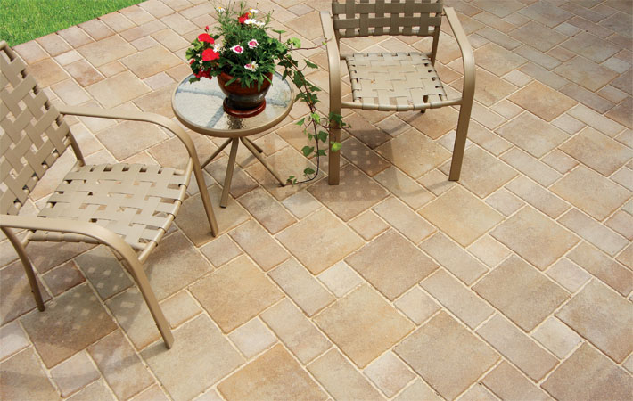 Verano paver brick patio with two outdoor chairs and flower pot